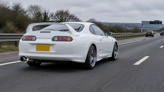 Japanese performance car with a 3-inch exhaust cruising on a UK motorway